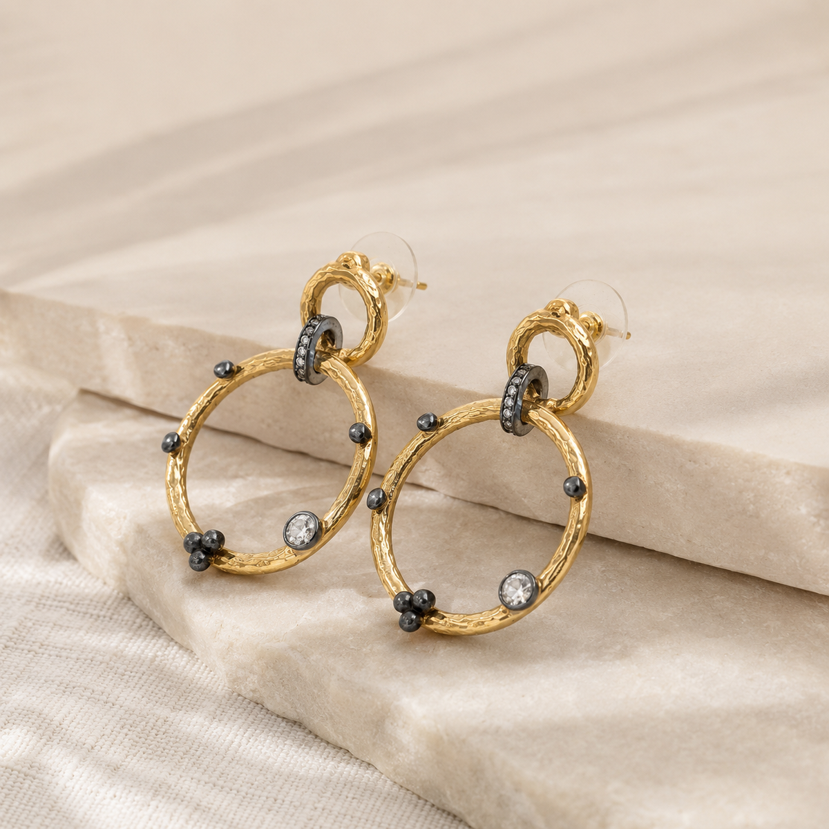 Angle view of double circle gold-plated dangle earrings.