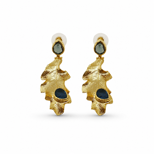 Gold leaf drop earrings with deep blue stone accents.