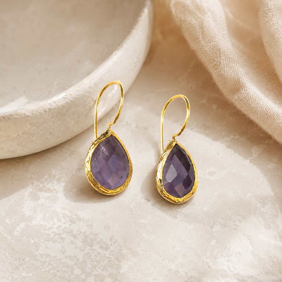 Amethyst drop earrings with a polished gold-plated finish.