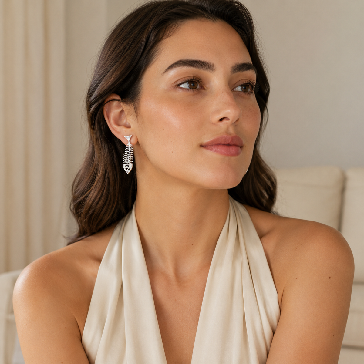 Silver fish bone earrings with CZ detail and a modern statement look.