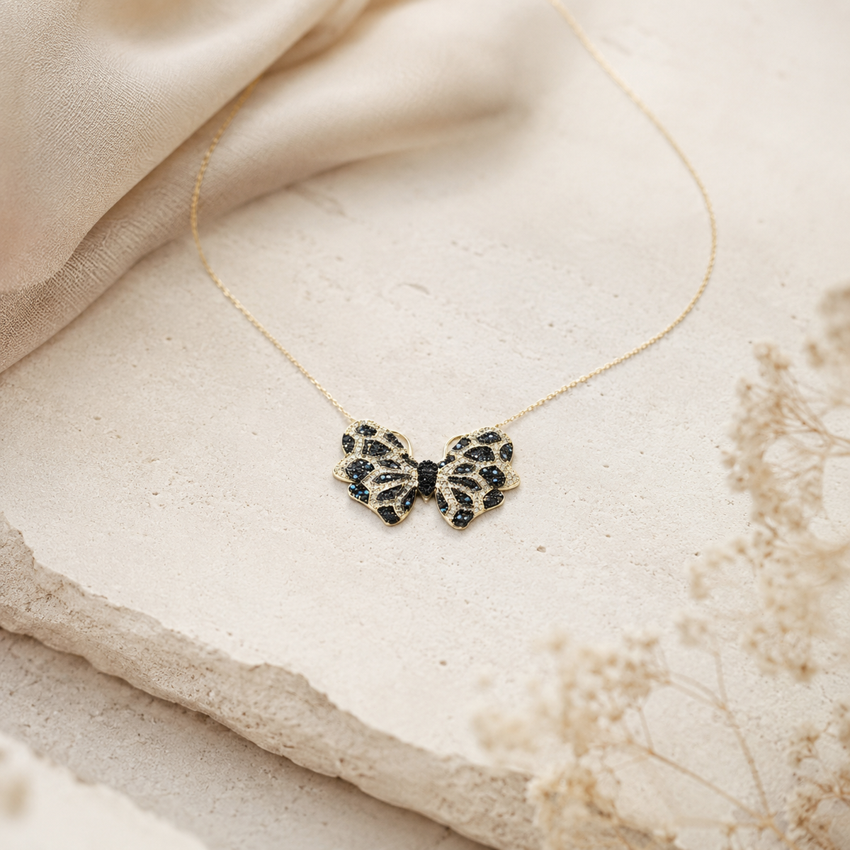 Butterfly pendant necklace with a delicate gold-tone chain.