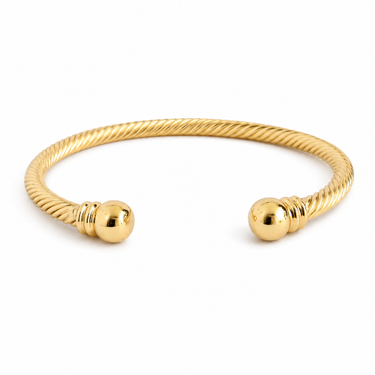 Gold-tone twisted open cuff bracelet with polished ball ends.