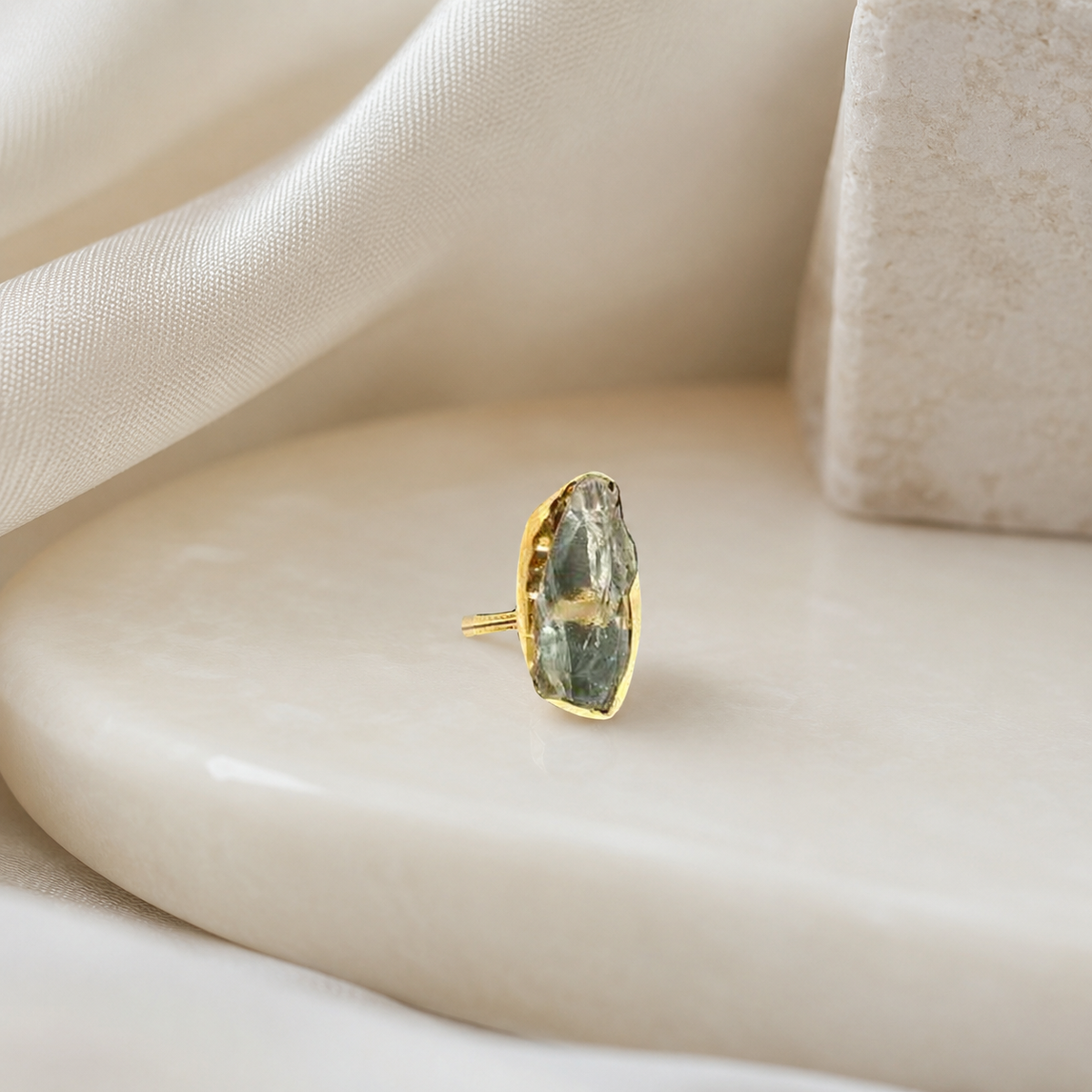 Gold-plated statement ring with a raw green amethyst center.