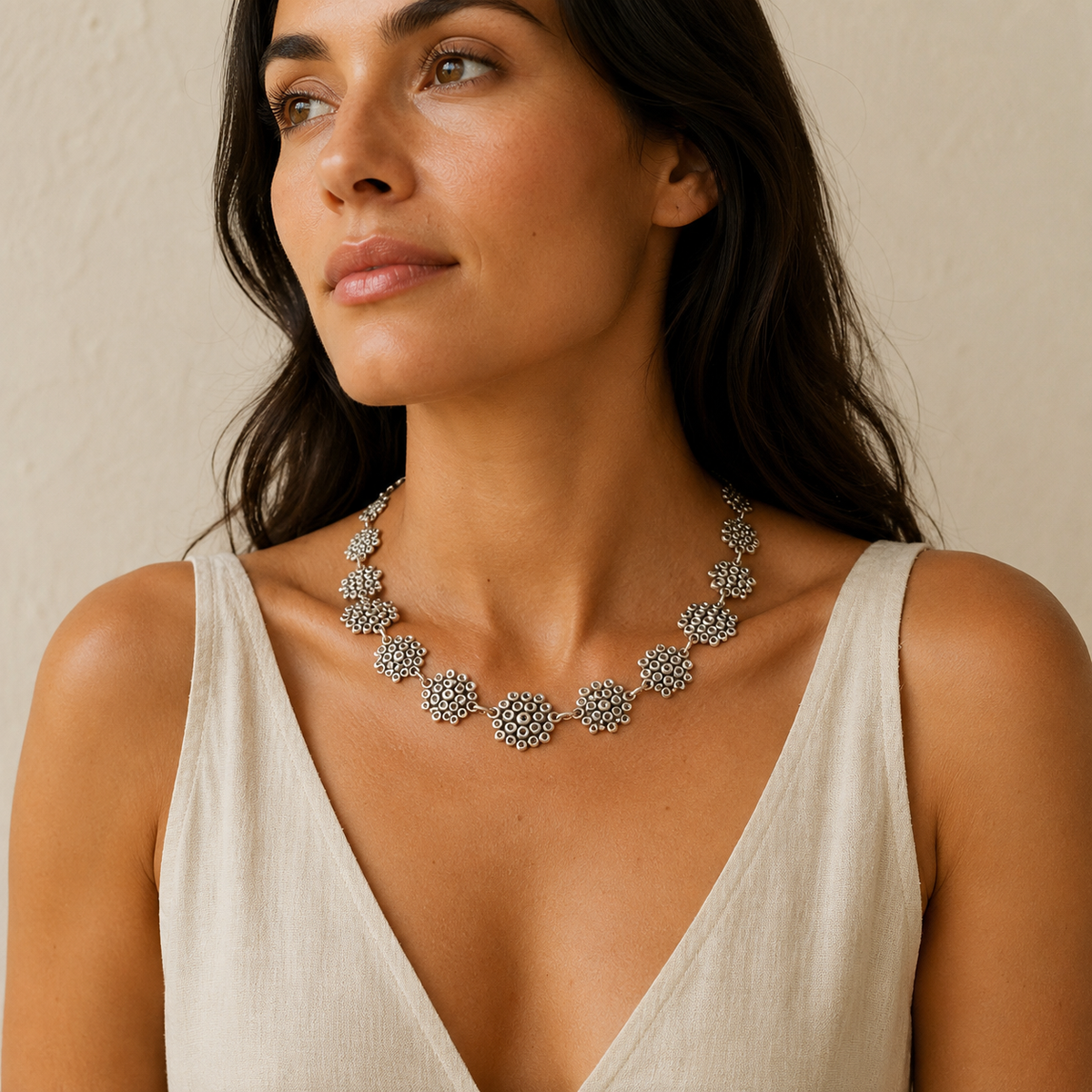 Silver-tone statement necklace with linked heart-inspired motifs in a clean product image.