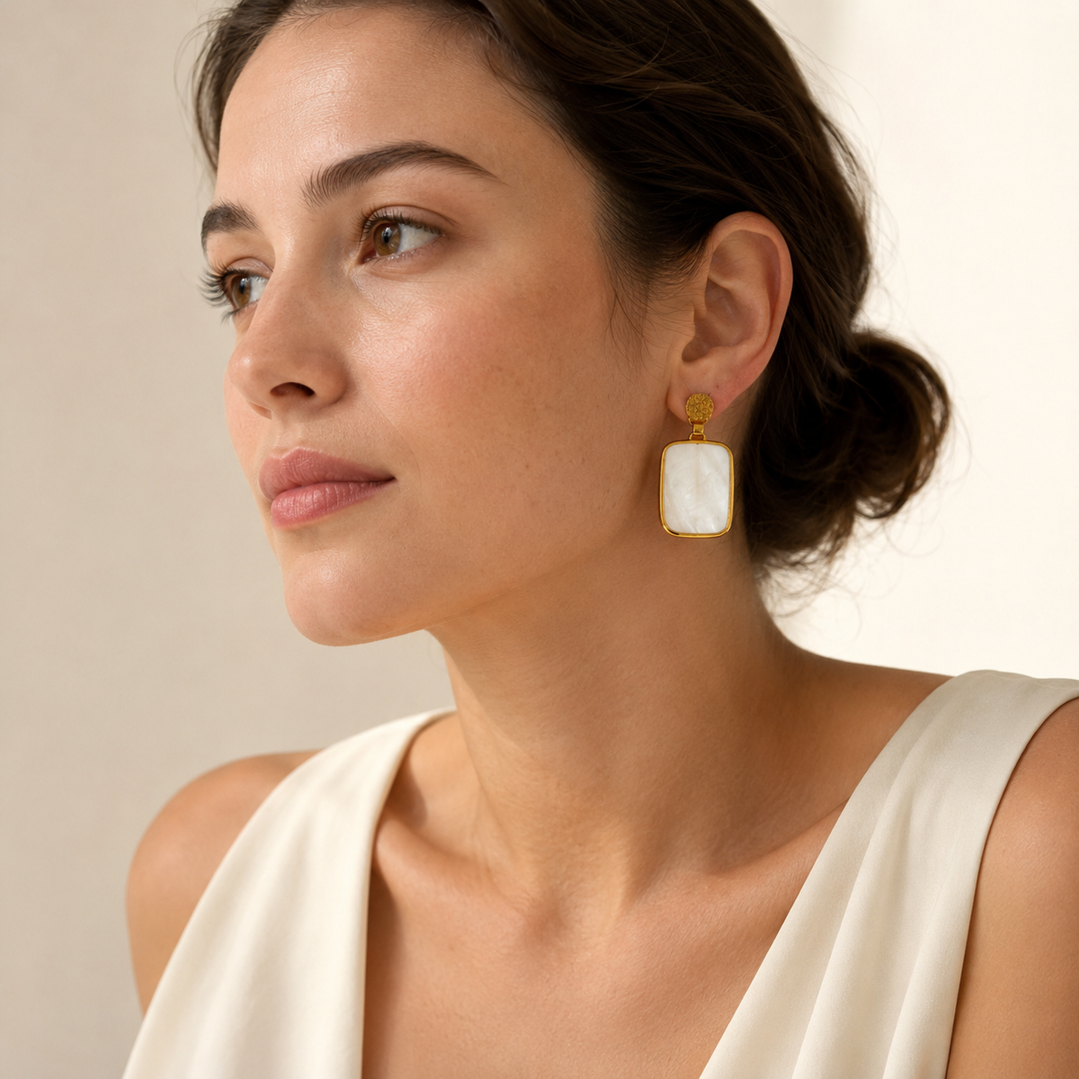 Clear quartz drop earrings with a gold plated finish and organic texture.