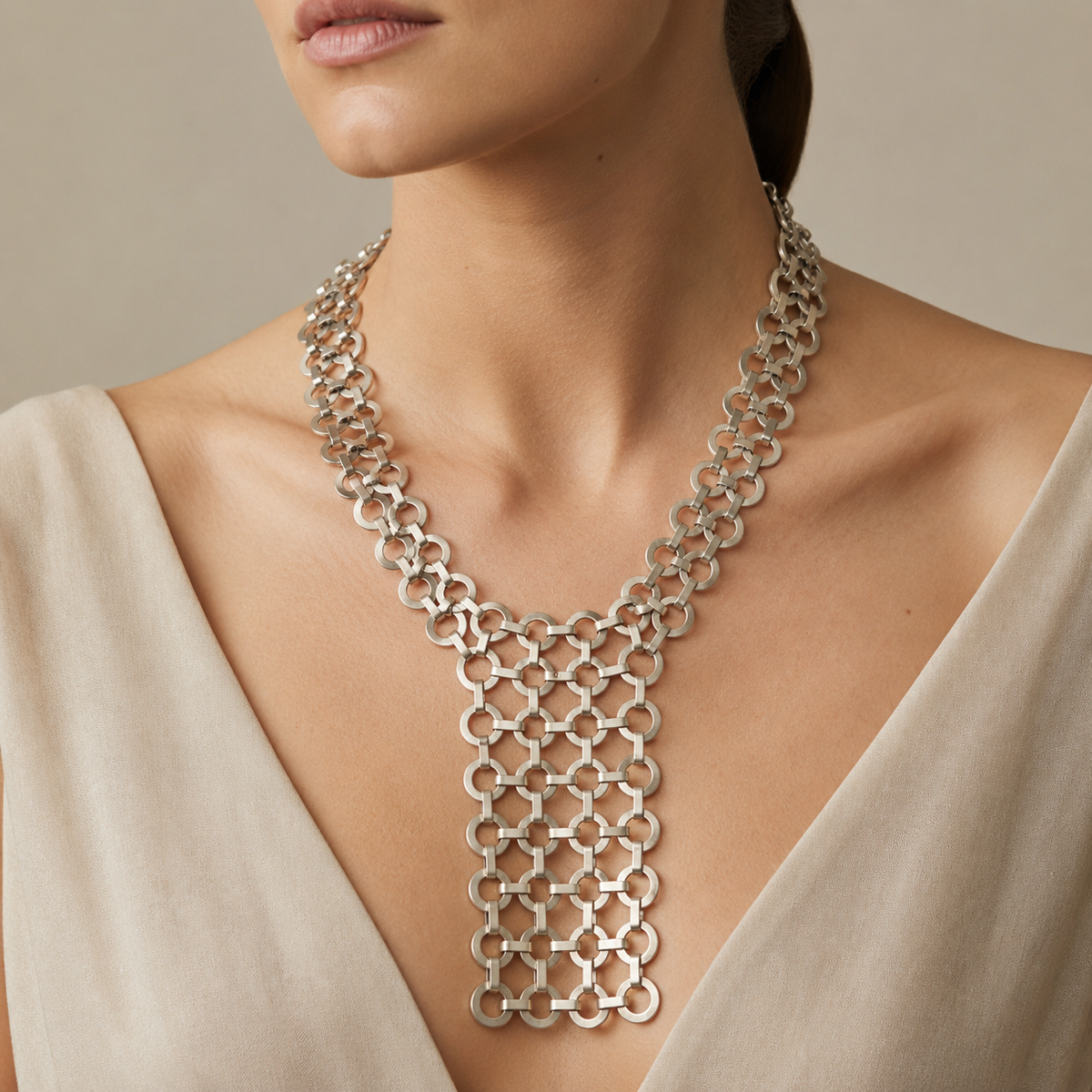 Silver link bib statement necklace shown from the front on a white background.