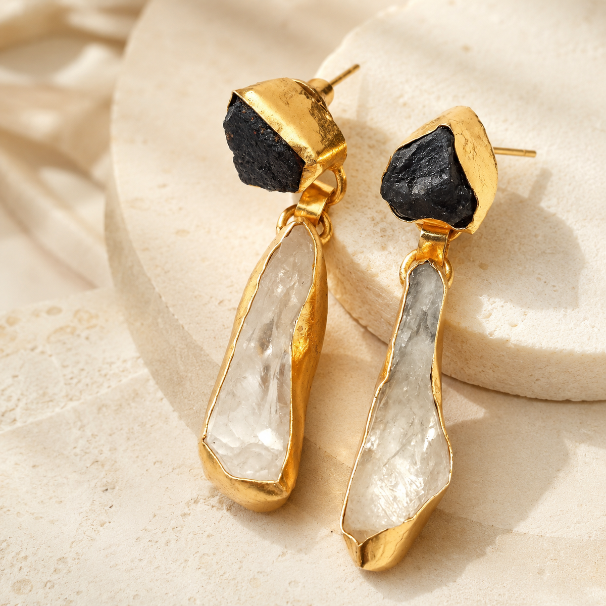 Angled view of gold-plated amethyst quartz drop earrings.