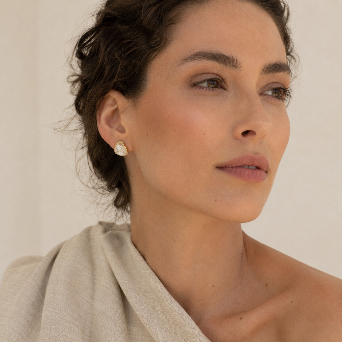 Pair of raw quartz stud earrings with an organic silhouette.