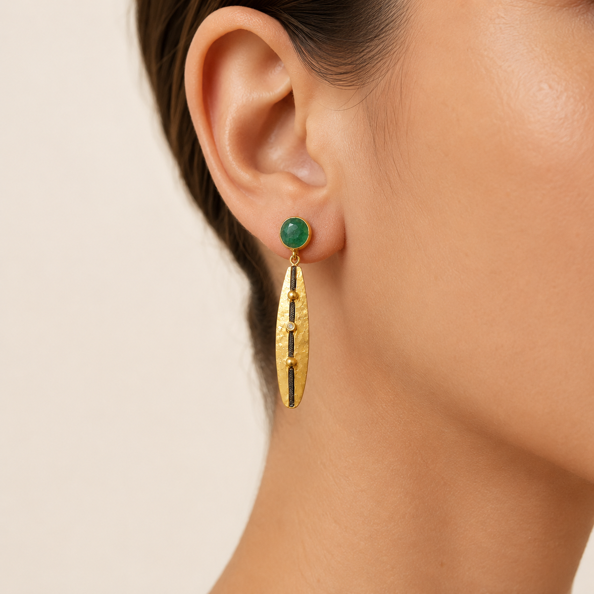 Pair of green stone drop earrings with a gold-plated finish.