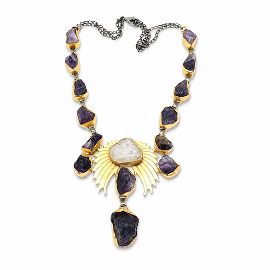Statement necklace with purple amethyst crystal-like stones and a gold-tone wing-inspired center.