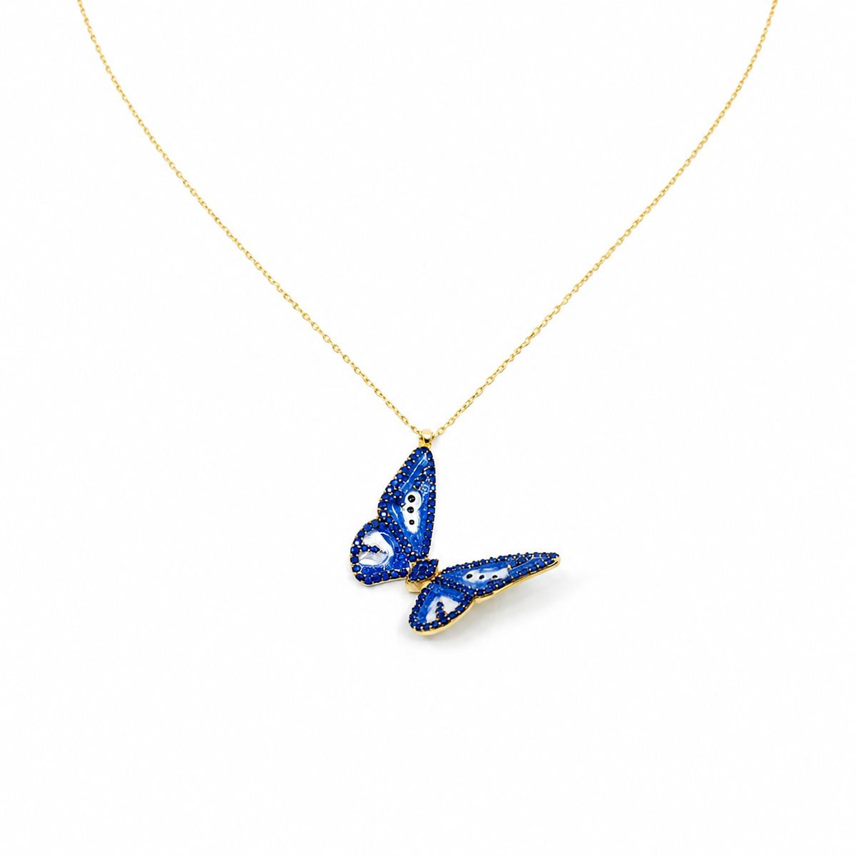 Gold-tone necklace with a navy enamel butterfly pendant.