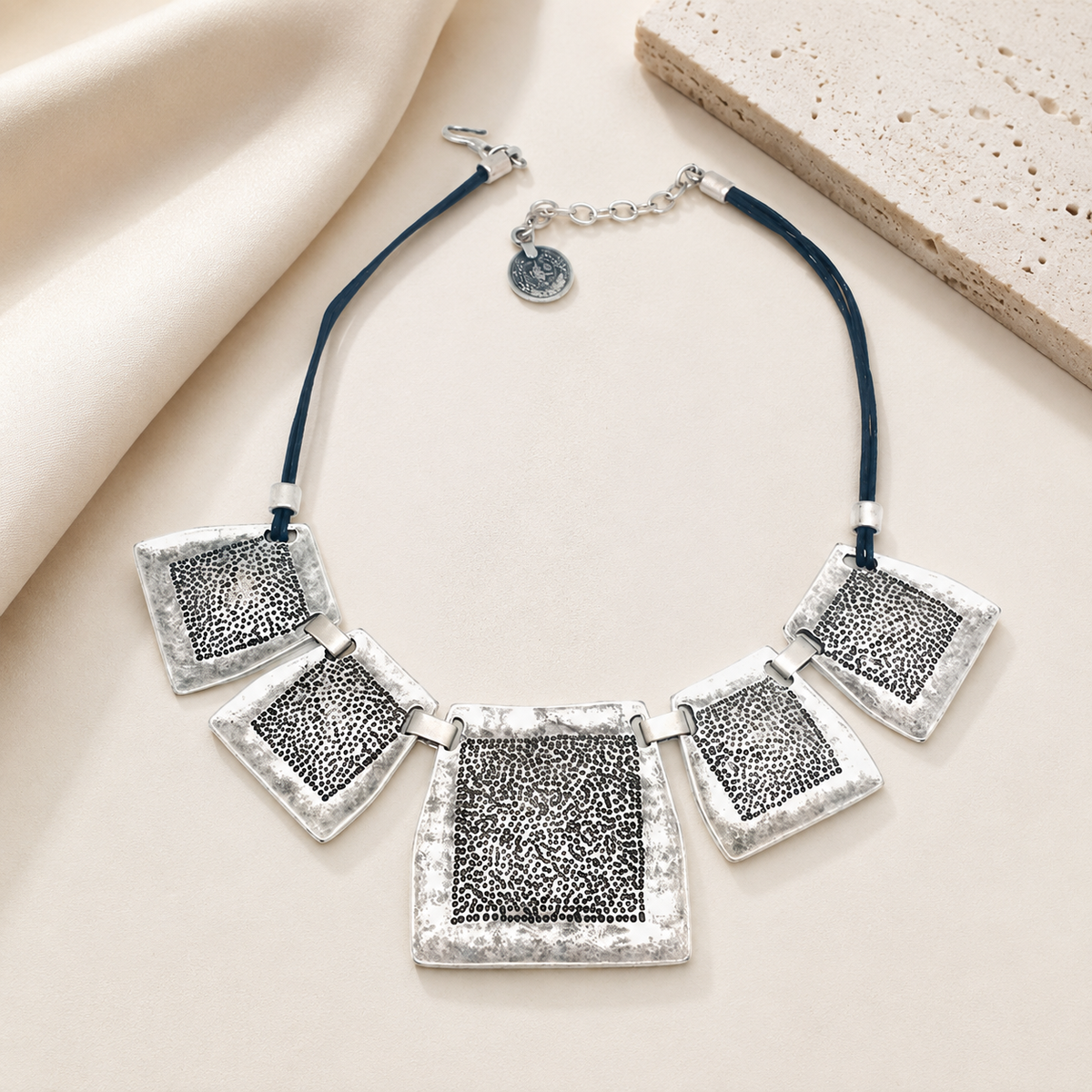 Textured square plate necklace with a modern silver-tone look.