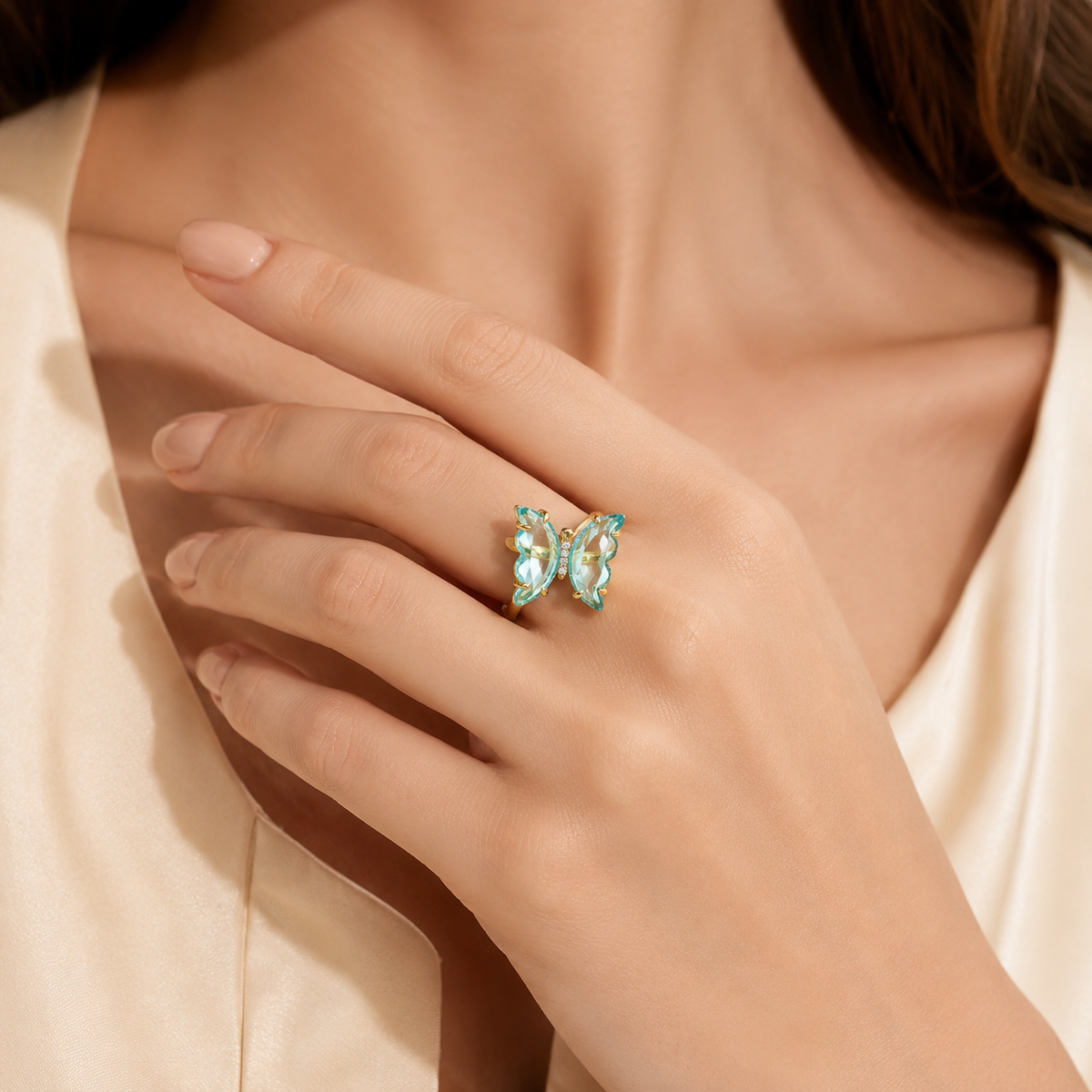 Gold butterfly ring with sky blue topaz and sparkling CZ detail.