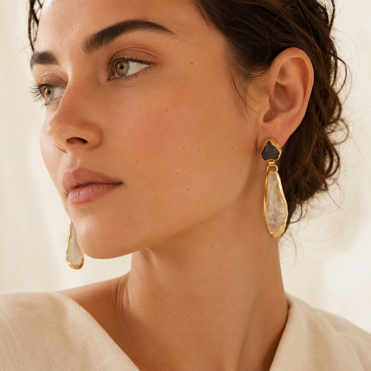 Gold-plated drop earrings with a sculptural stone shape.