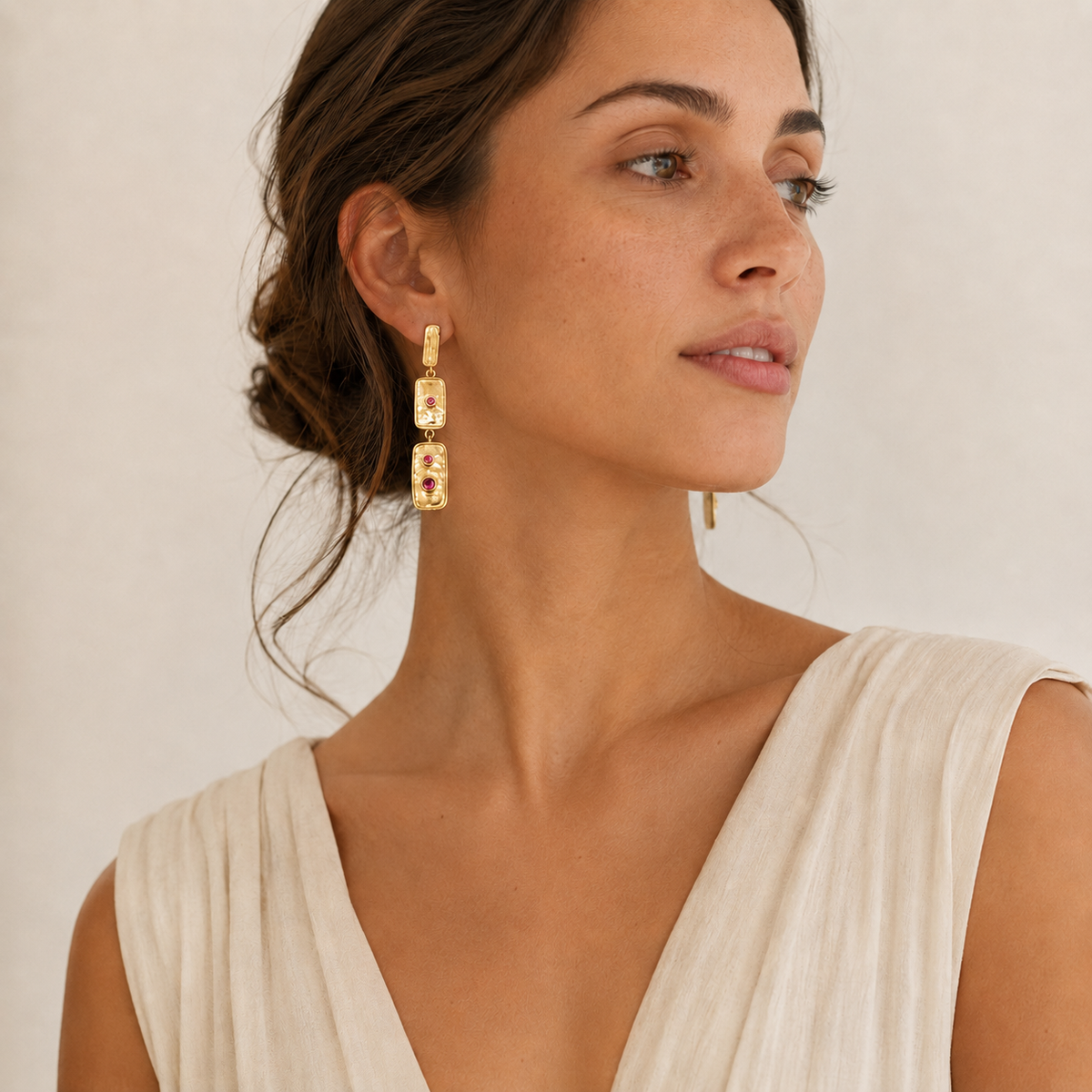 Statement drop earrings with three linked rectangles and pink stone accents.