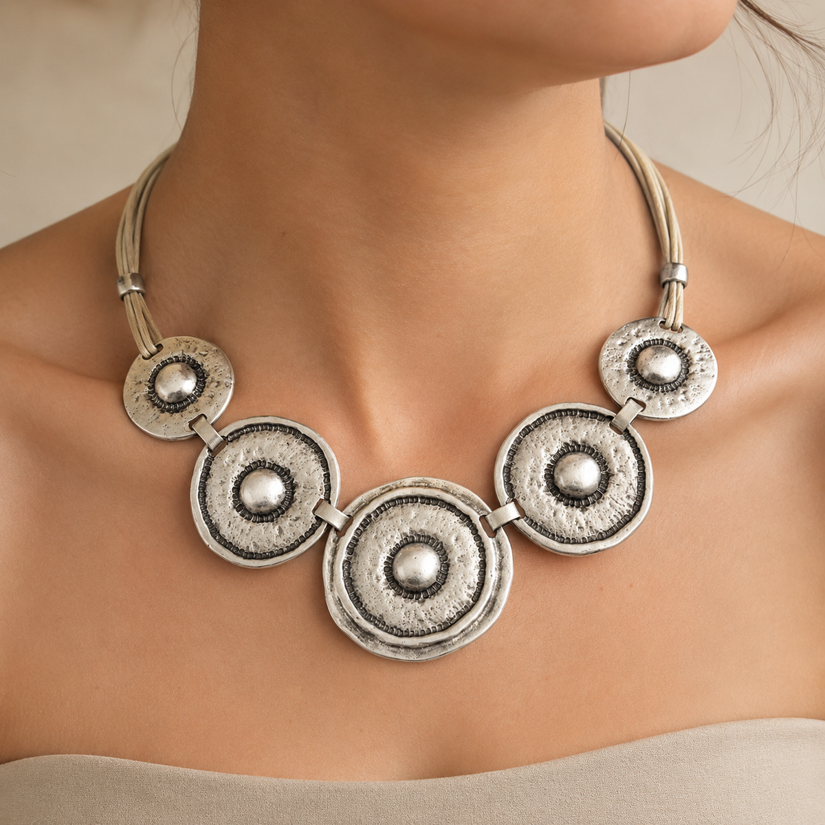 Hammered silver-tone circle statement necklace shown from the front.