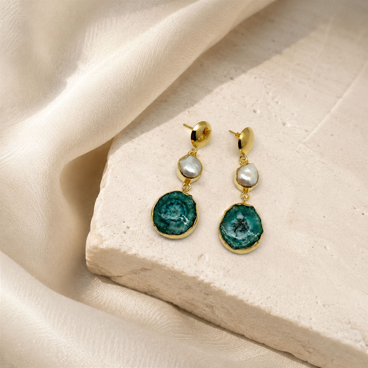 Gold-plated drop earrings with a baroque pearl and green agate pendant on a white background.