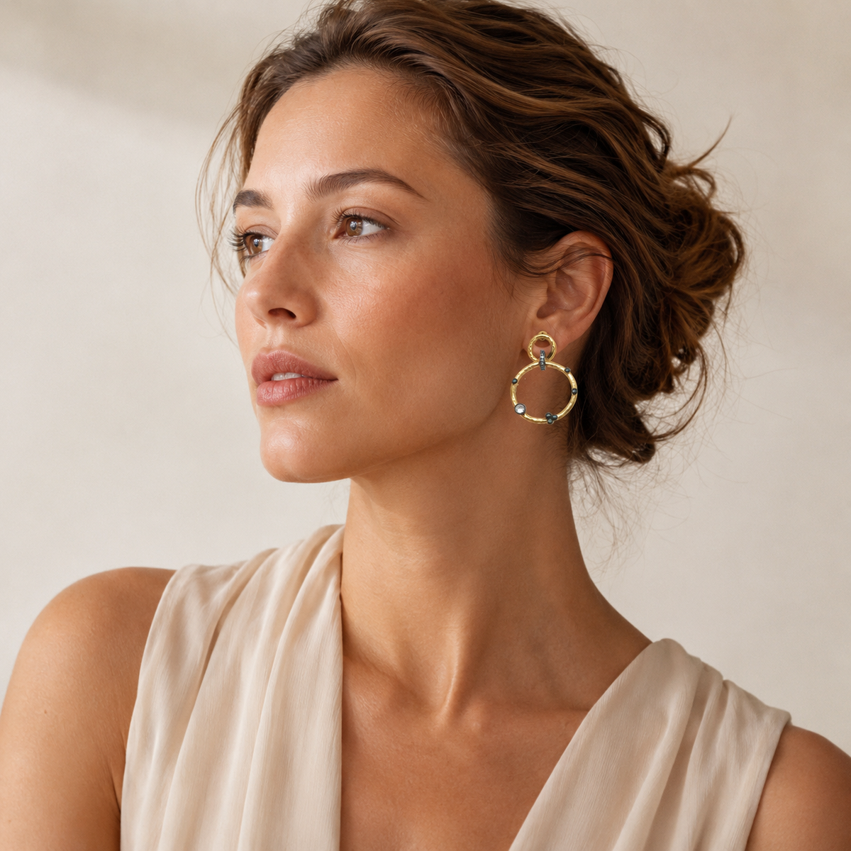 Gold-plated double circle dangle earrings with sculptural shape.