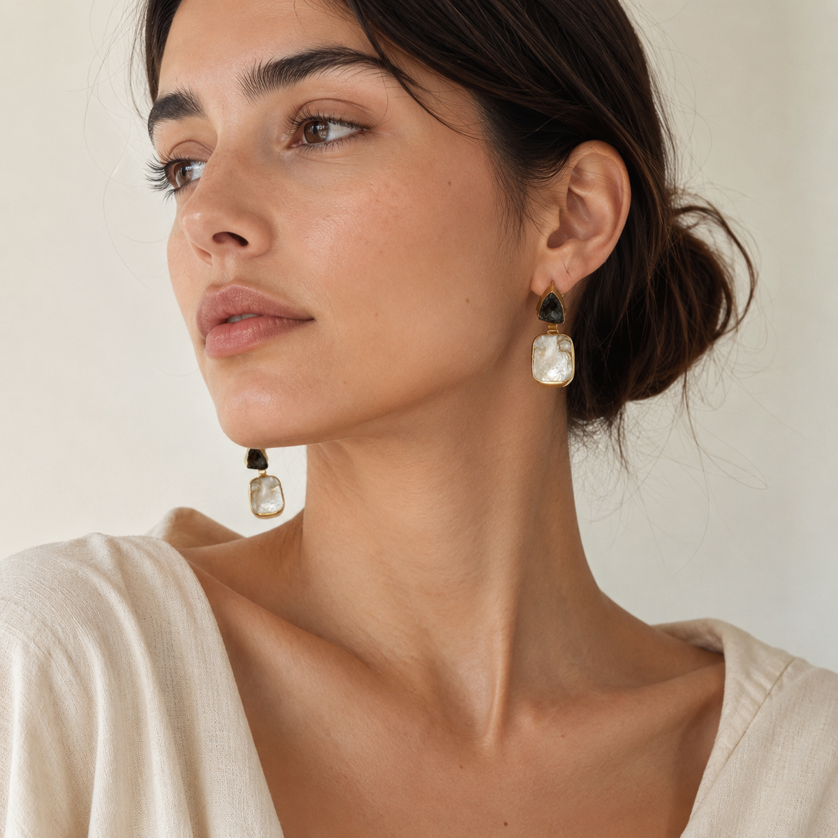 Sculptural gold-plated earrings with smoky quartz and mother of pearl.