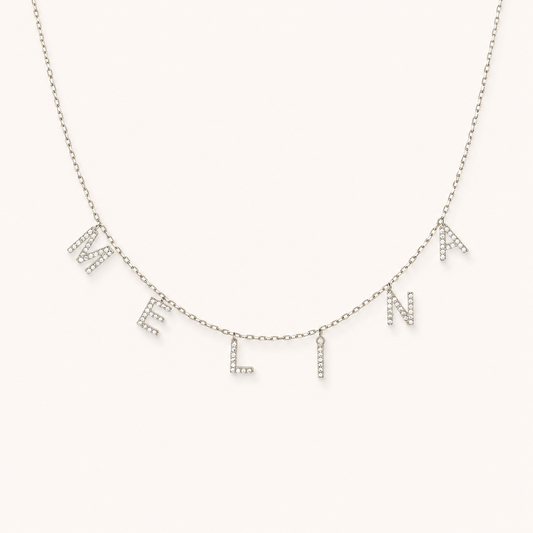 Personalized letter necklace with CZ accents on a delicate chain.