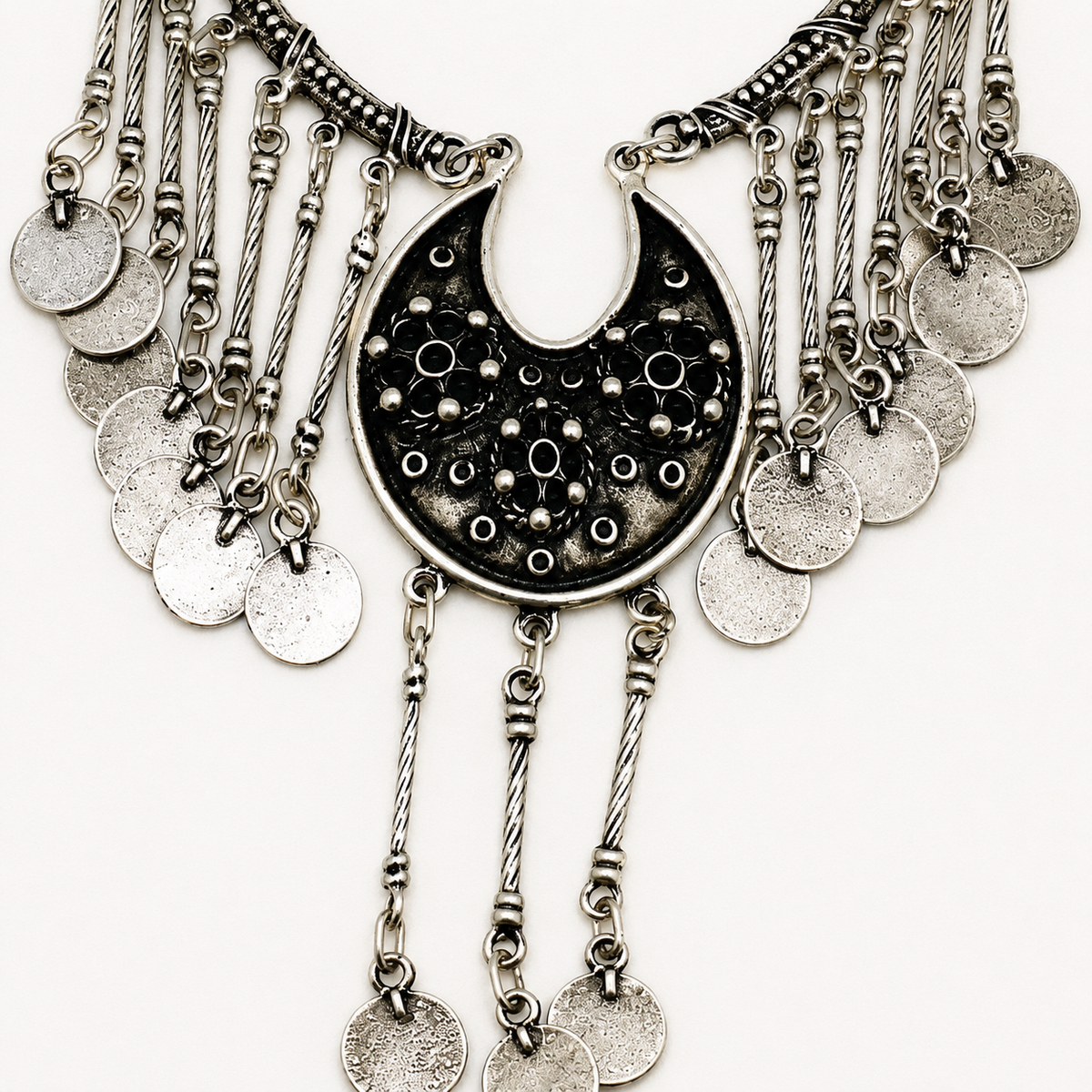 Close view of the black beaded pendant and dangling chain accents.