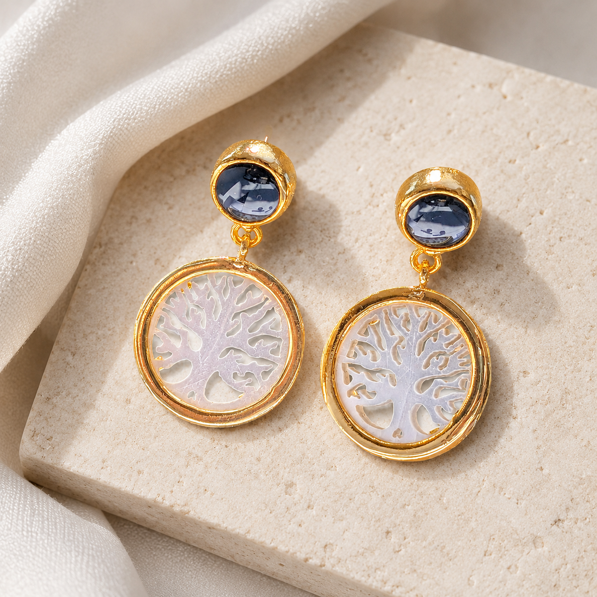 Gold-plated drop earrings with a Tree of Life motif on a white background.