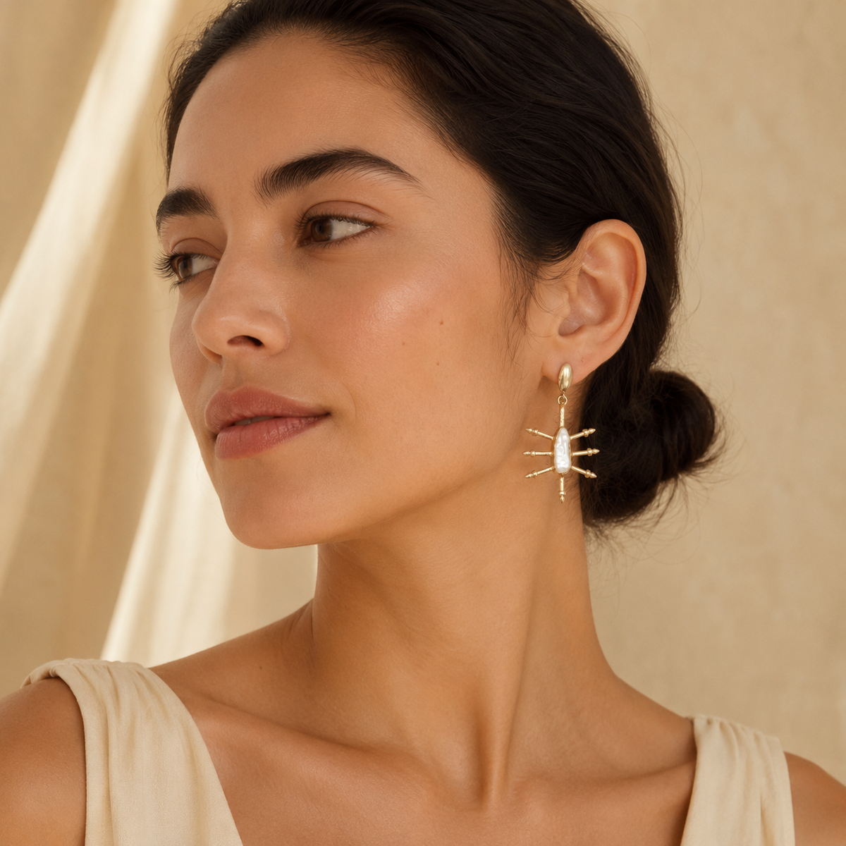 Pair of gold-plated earrings with a cushion-shaped blue sapphire look and polished hook tops.