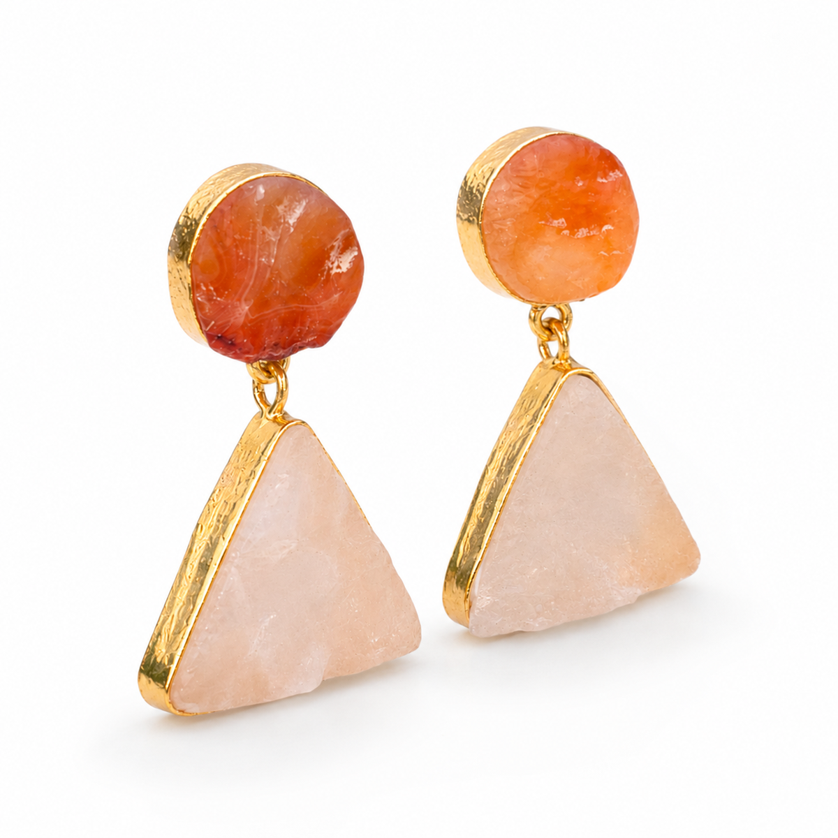 Angle view of gold-plated drop earrings with rough rose quartz and carnelian stones.