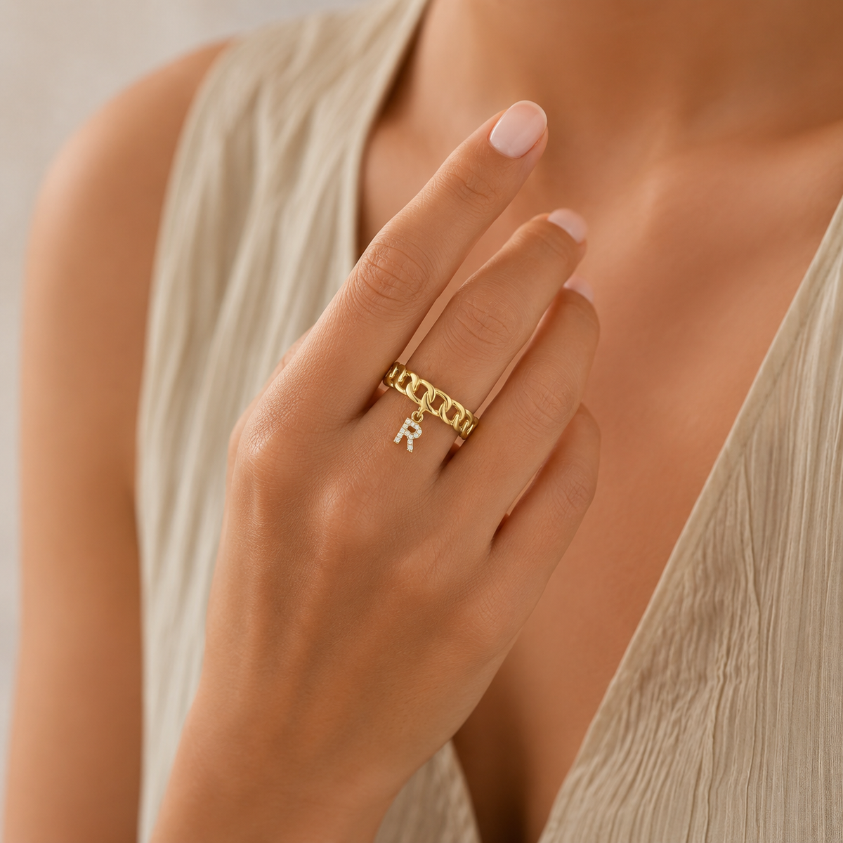 Personalized gold-tone ring with a CZ letter charm.