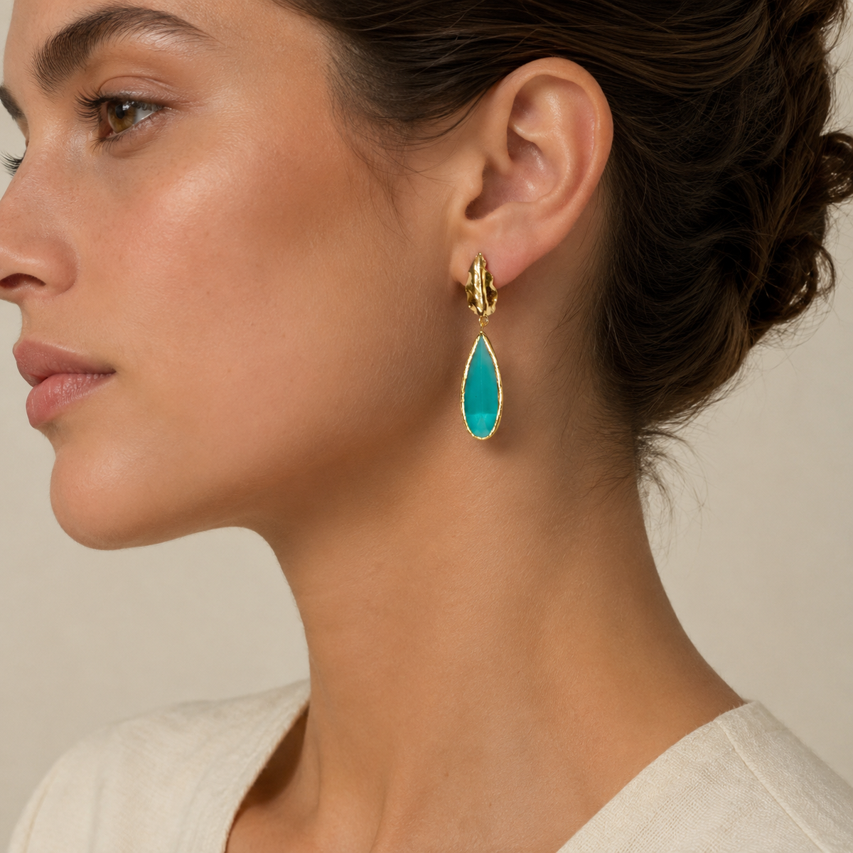 Gold-plated leaf drop earrings with pine green teardrop accents.