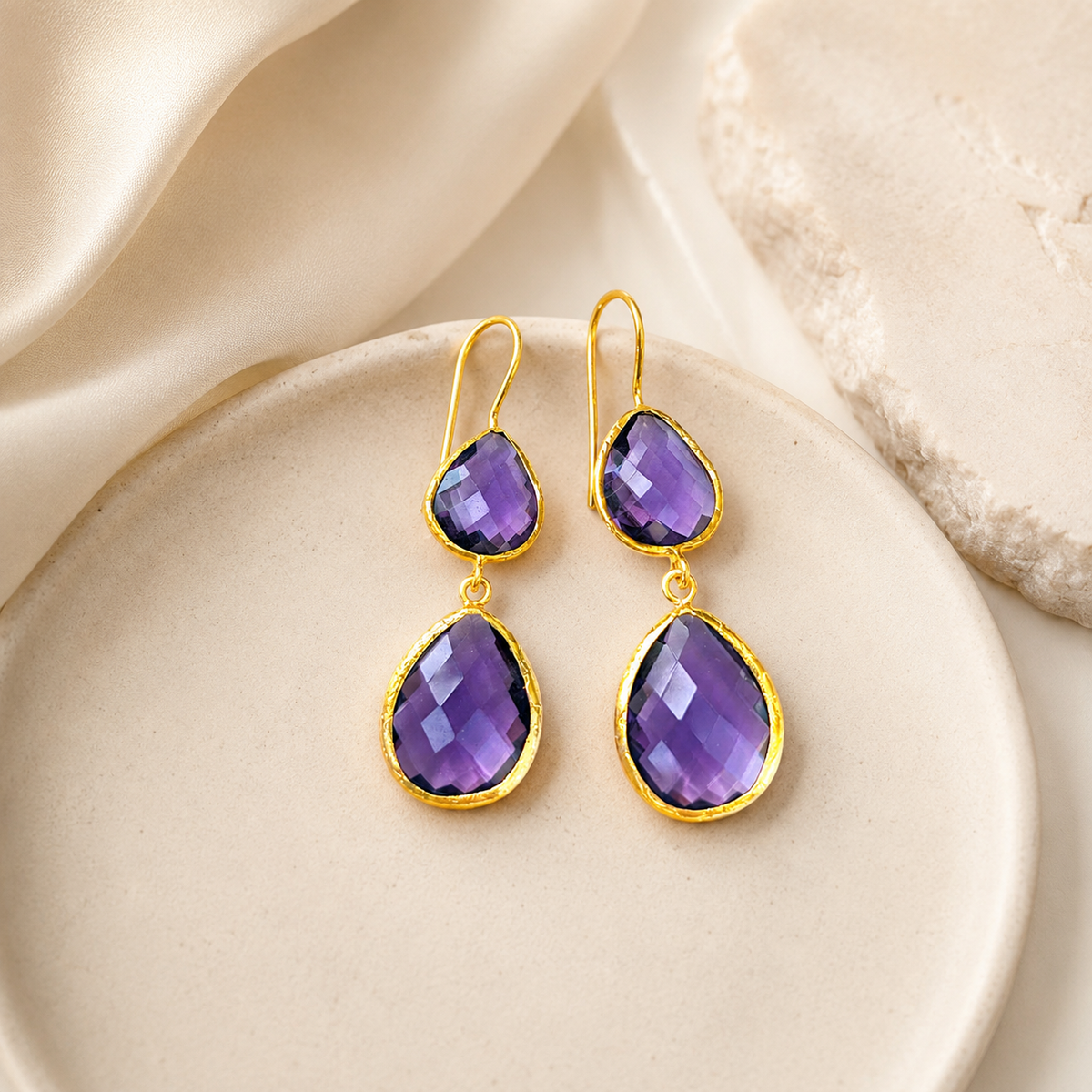 Gold-plated drop earrings with purple amethyst stones.