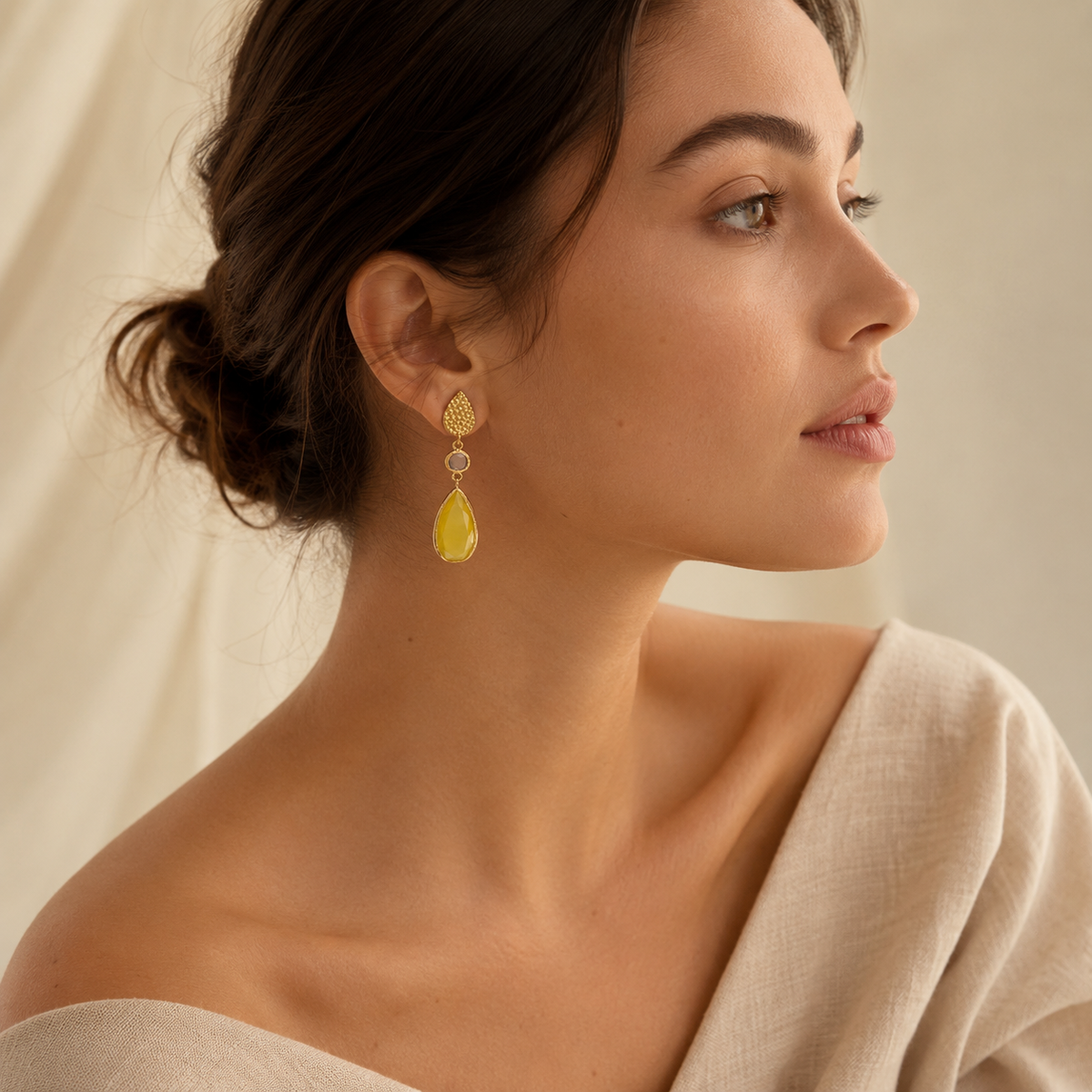 Long hammered gold-plated earrings with a textured teardrop top and faceted stone drops.