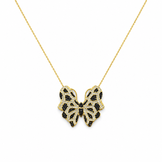 Gold-tone necklace with a butterfly pendant and multicolor CZ accents on a white background.