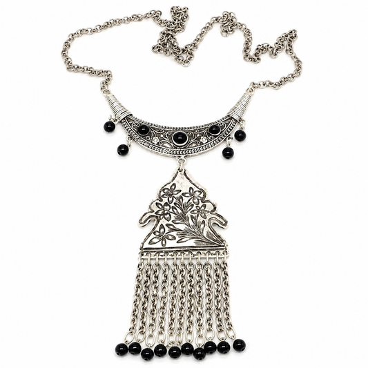 Black bead floral pendant necklace with silver-tone chain tassels.