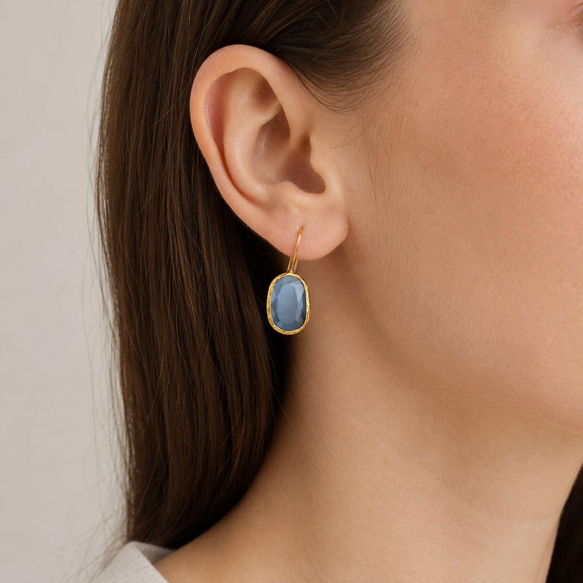 Smoky gray cat eye teardrop earrings shown in a front view.