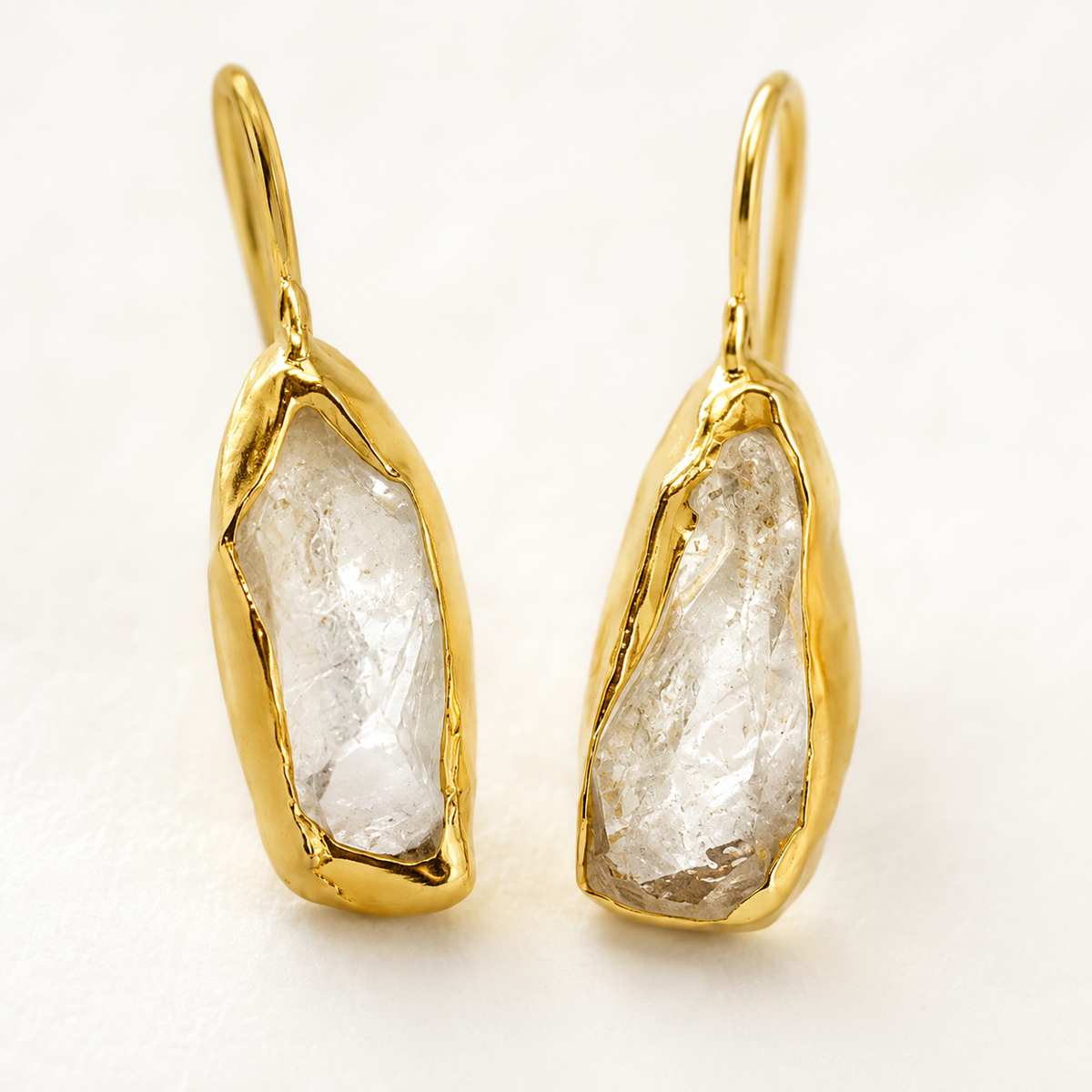 Close view of the clear quartz stone and gold-plated setting.
