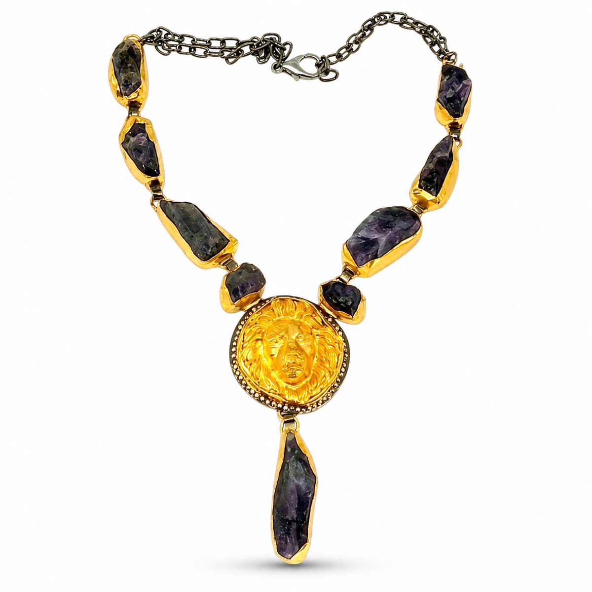 Purple raw stone statement necklace with a gold-tone sunburst pendant.