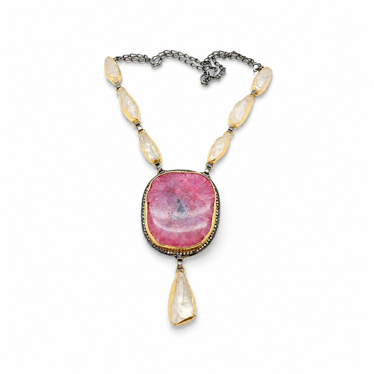 Pink solar stone teardrop necklace with gold-tone accents and a statement pendant.