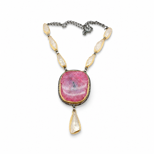 Pink solar stone teardrop necklace with gold-tone accents and a statement pendant.
