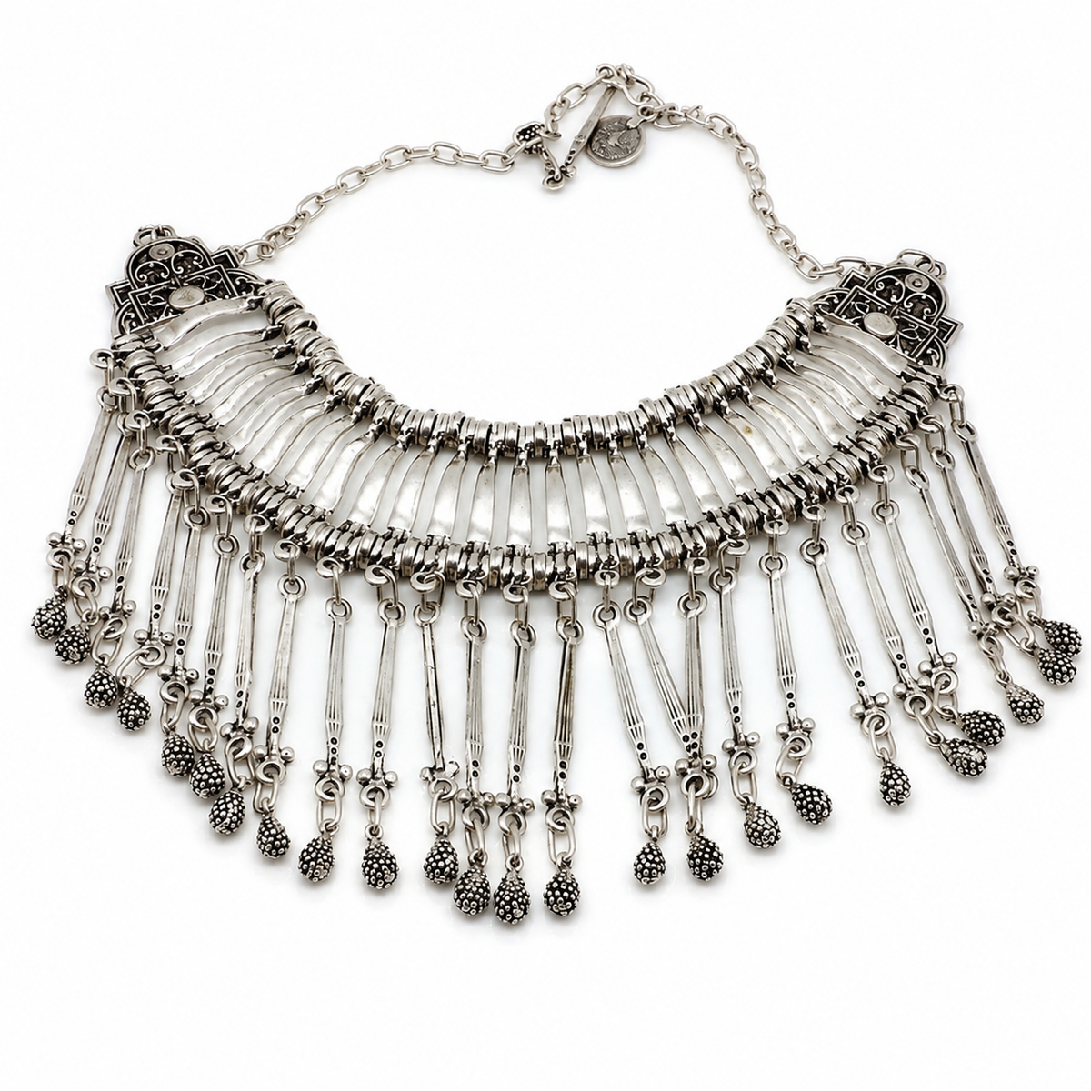 Silver-tone bib necklace with layered chain fringe and textured drop details.