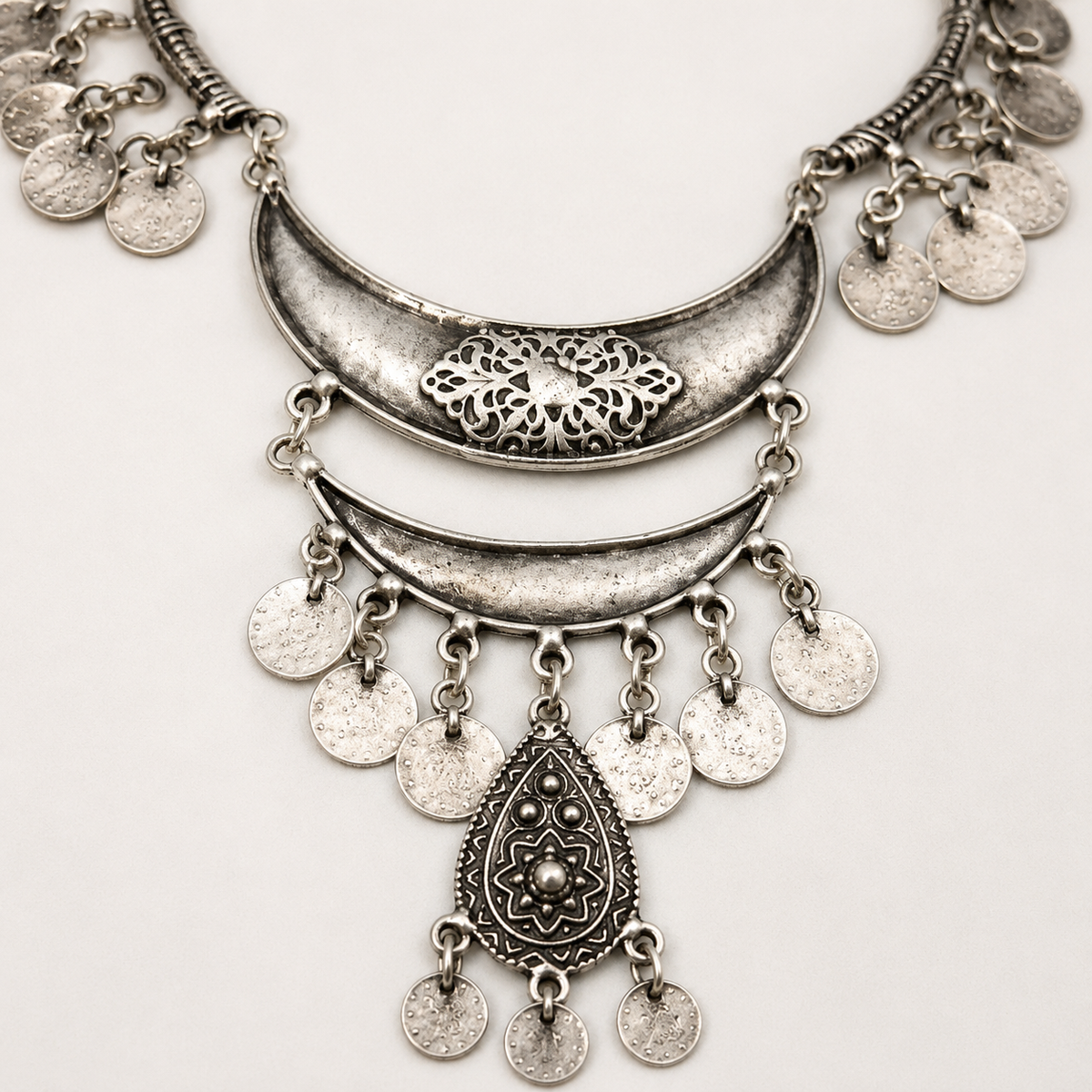 Close view of the textured silver-tone coin fringe and center detail.
