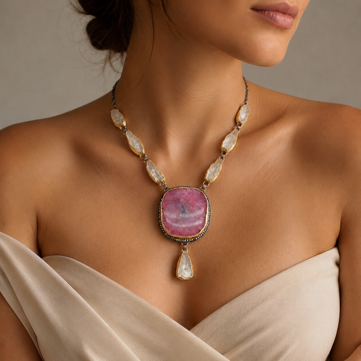 Pink solar stone pendant necklace with a bold center stone and matching accents.