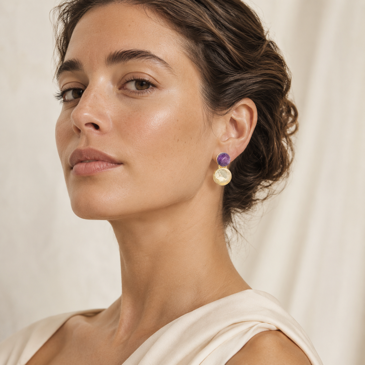 Pair of statement drop earrings with rough amethyst, clear quartz, and a polished gold-plated frame.