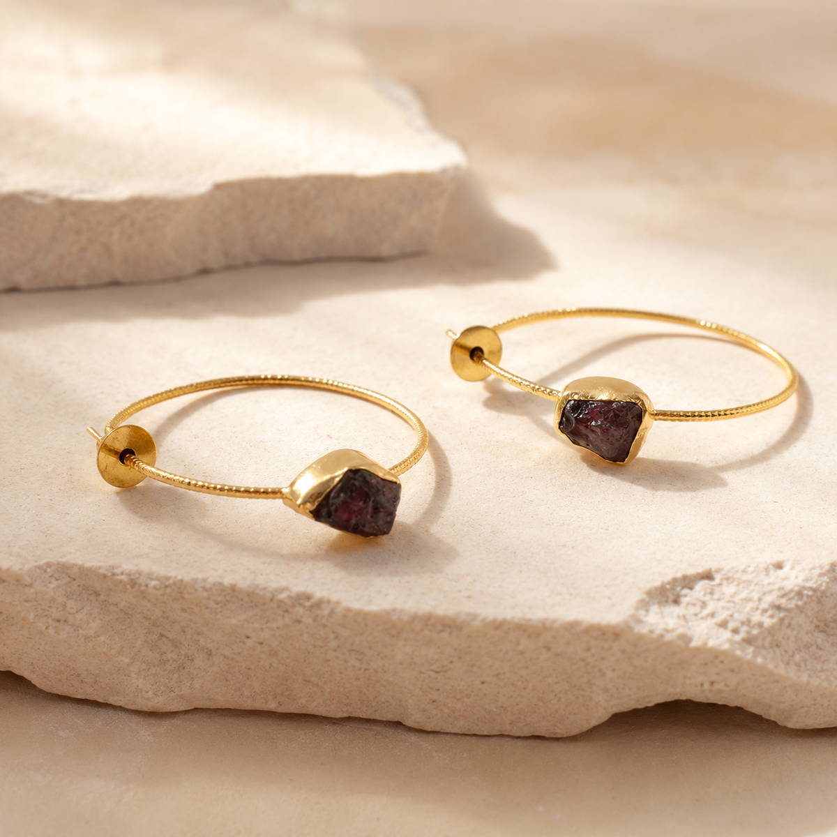 Angle view of gold-plated hook earrings with green agate slice stones.