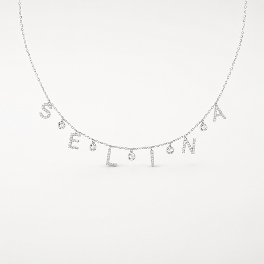 A silver-tone personalized necklace with sparkling drop letter charms on a delicate chain.