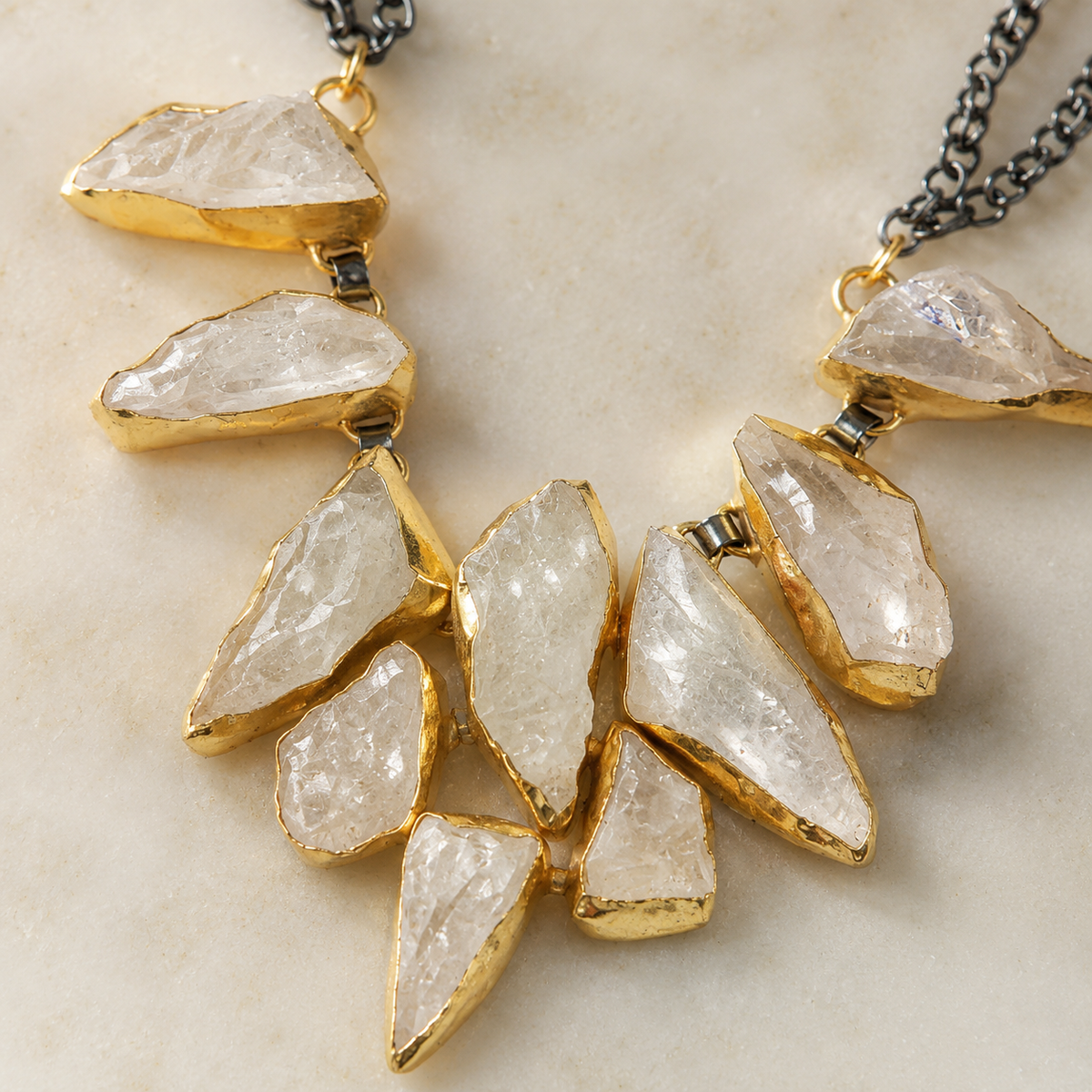 Close view of the necklace’s clear stone pendants and gold-tone edges.