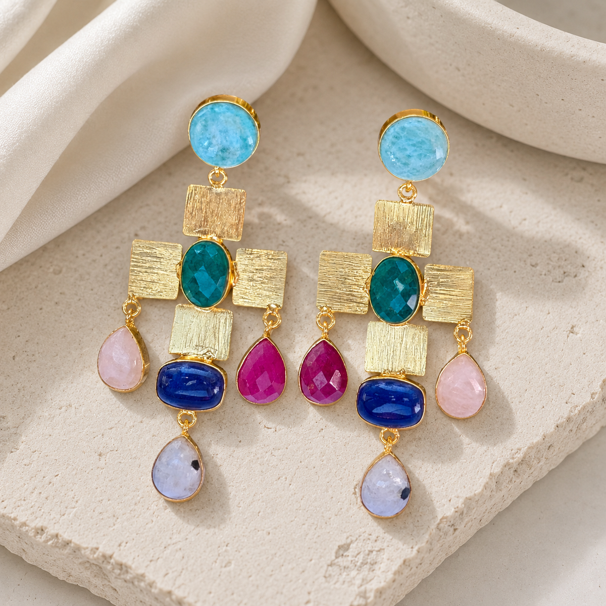 Gold-plated statement earrings with a cross-shaped mosaic design and colorful stone accents.
