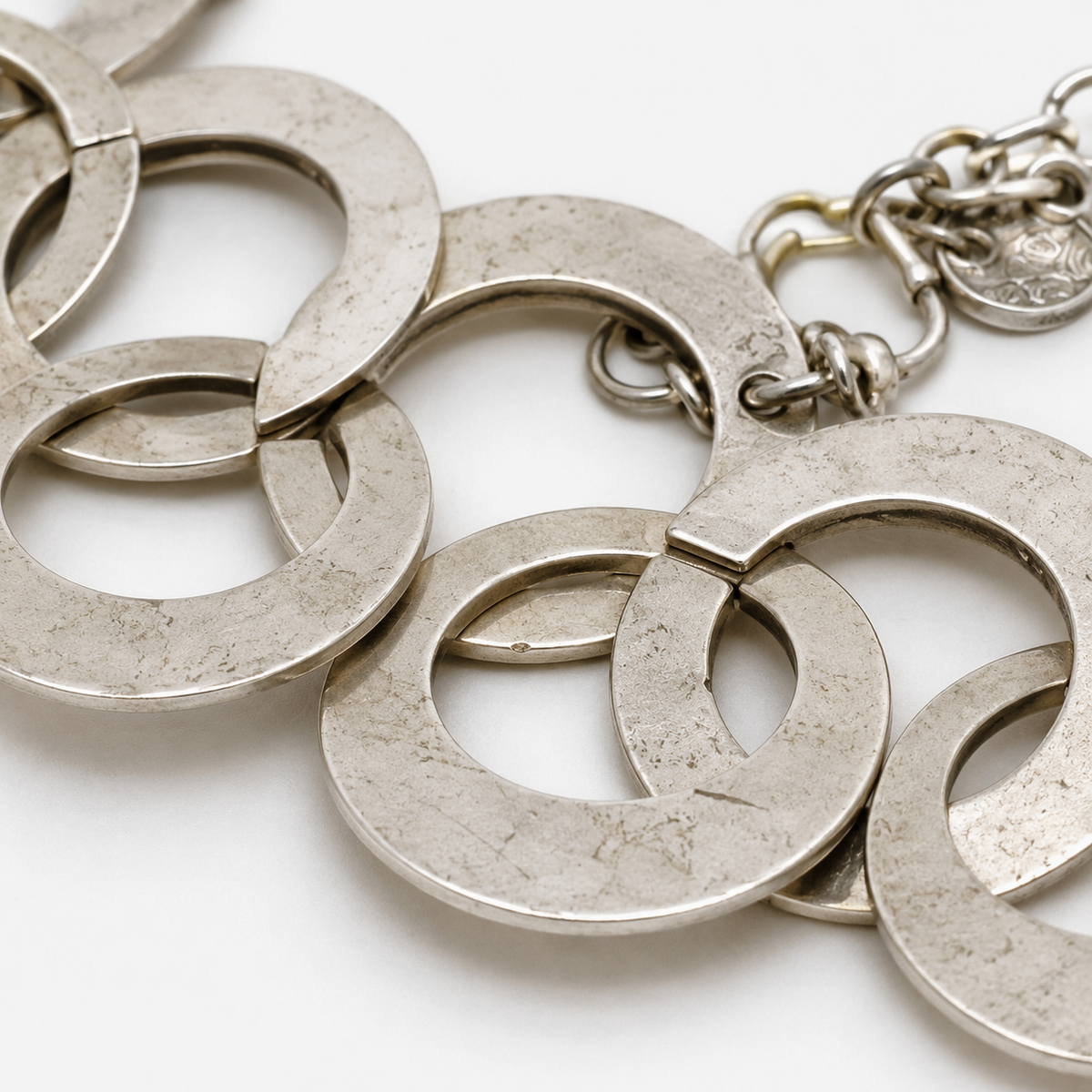 Close view of the smooth circular links and polished silver-tone finish.