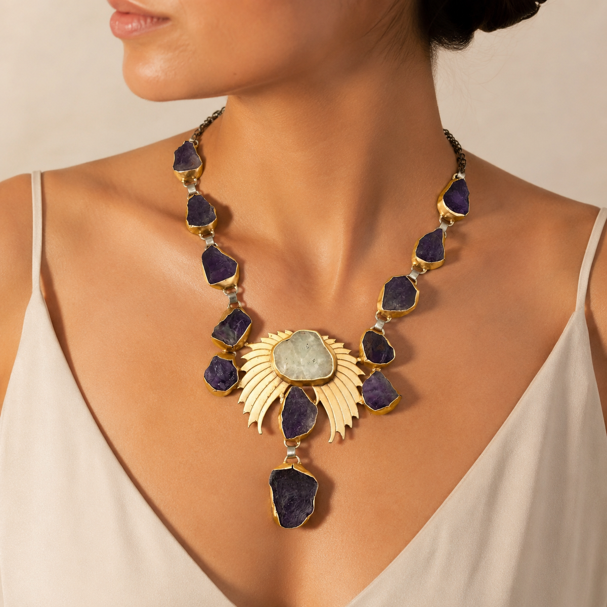 Amethyst crystal wing statement necklace with a bold pendant silhouette and gold-tone accents.