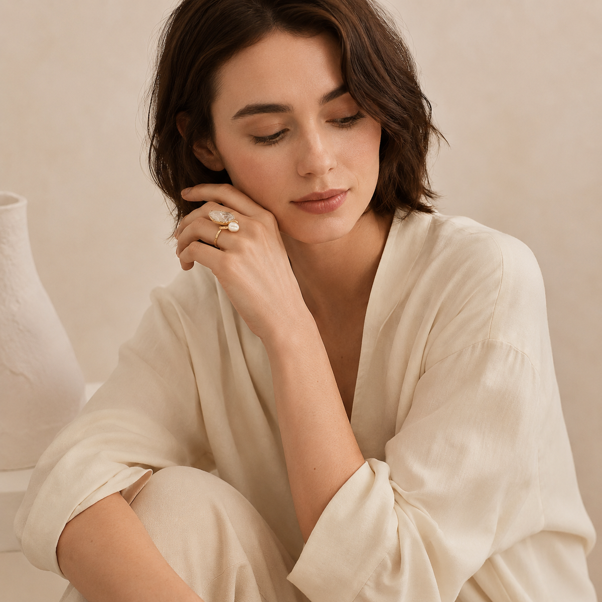 Two-stone gold-plated ring with a clear quartz stone and pearl-like accent.